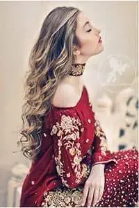 The accompanying trousers are equally striking, with deep red embellished motifs implemented at their bottom for a harmonious flow. A delicate net dupatta, scattered with a shimmering stone spray, adds an ethereal layer to the ensemble. This party wear outfit is a testament to meticulous handcraft, featuring rich embroidery in kora, dabka, and sequins. Crafted from the highest quality imported fabric, it promises to make a bold and unforgettable statement. Every detail, from the precise stitching to the radiant color, is designed for a night of glamour and sophistication.