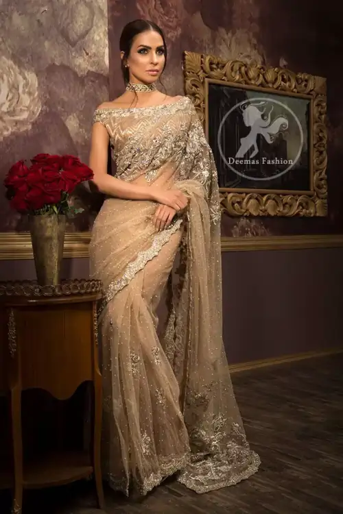 Banarsi jamawar blouse contains embroidered border on the neckline. Net saree contains flourishing embellishments all around the edges. Stones spray