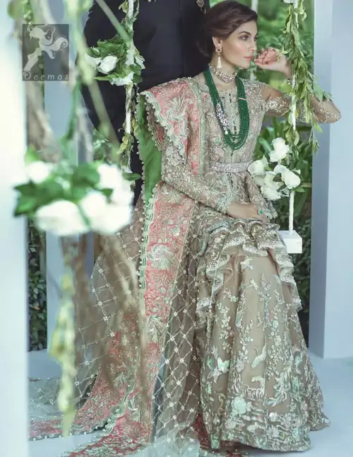 Fawn short length peplum made with net having embellished belt on waist. Large embellished border having peach appliqued on dupatta.