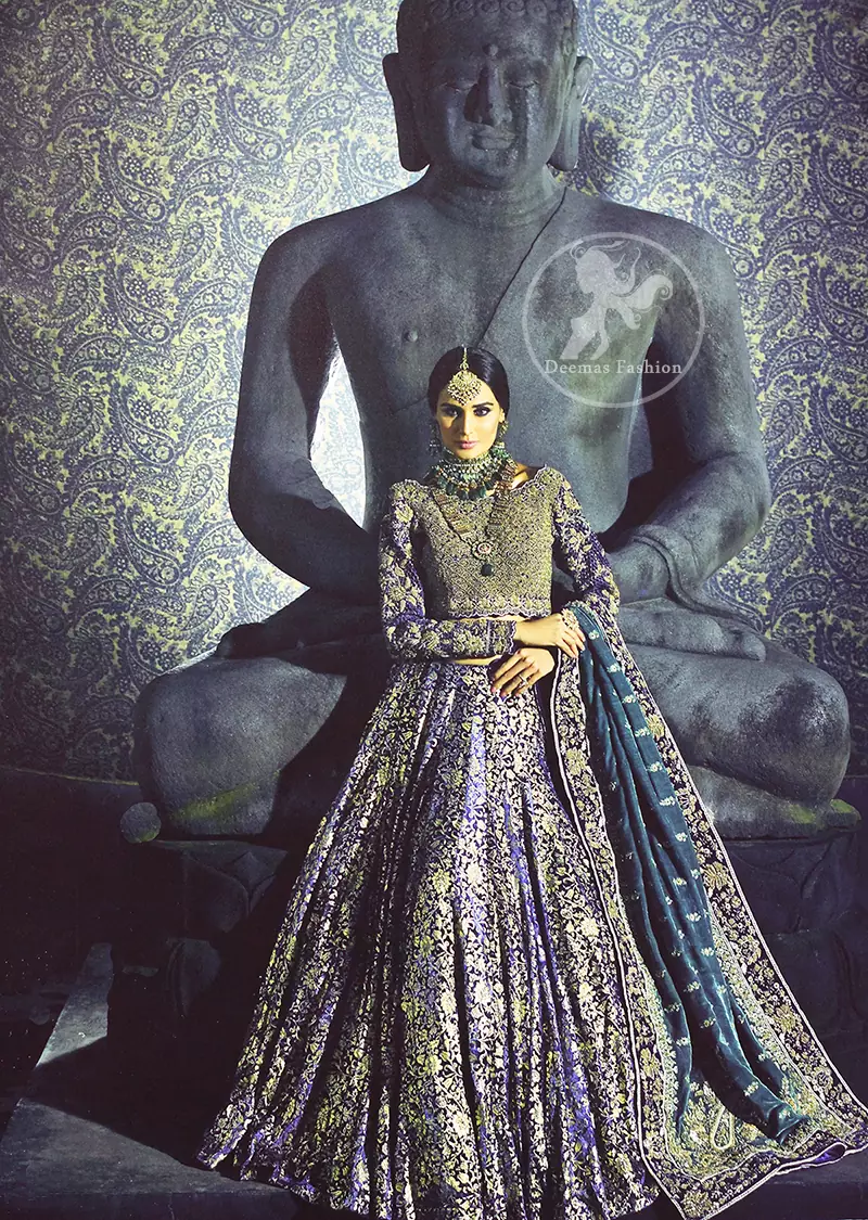 Violet Blue Blouse is of velvet fabric. It is heavy embellished ful sleeves blouse featuring antique and golden shaded kora, dabka, resham, naqshi, pearls, crystals and swarovski. Blouse is fully scalloped with blue bayoux resham outline. sleeves are adorned with floral work and sprinkling sequins/naqshi on it, while bodice having crossing heavy pattern all over it. It comes with raw silk lehengha which is adorned with block printing. It is artistically coordinated with blue bayoux dupatta which is adorned with fully embellished appliqued borders. Borders are accompnied by delicate work along its internal sides. There are four embellished heavy flowers on corners and small floral pattern all over it.