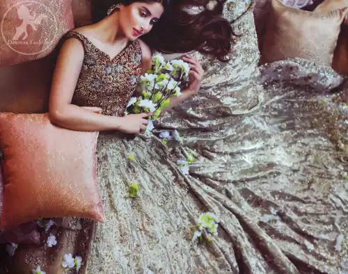 Redish brown exuberant velvety blouse is highlighted with moti, kora, dabka, pearls, swarovski, crystals, and sequins. This sleeveless blouse is