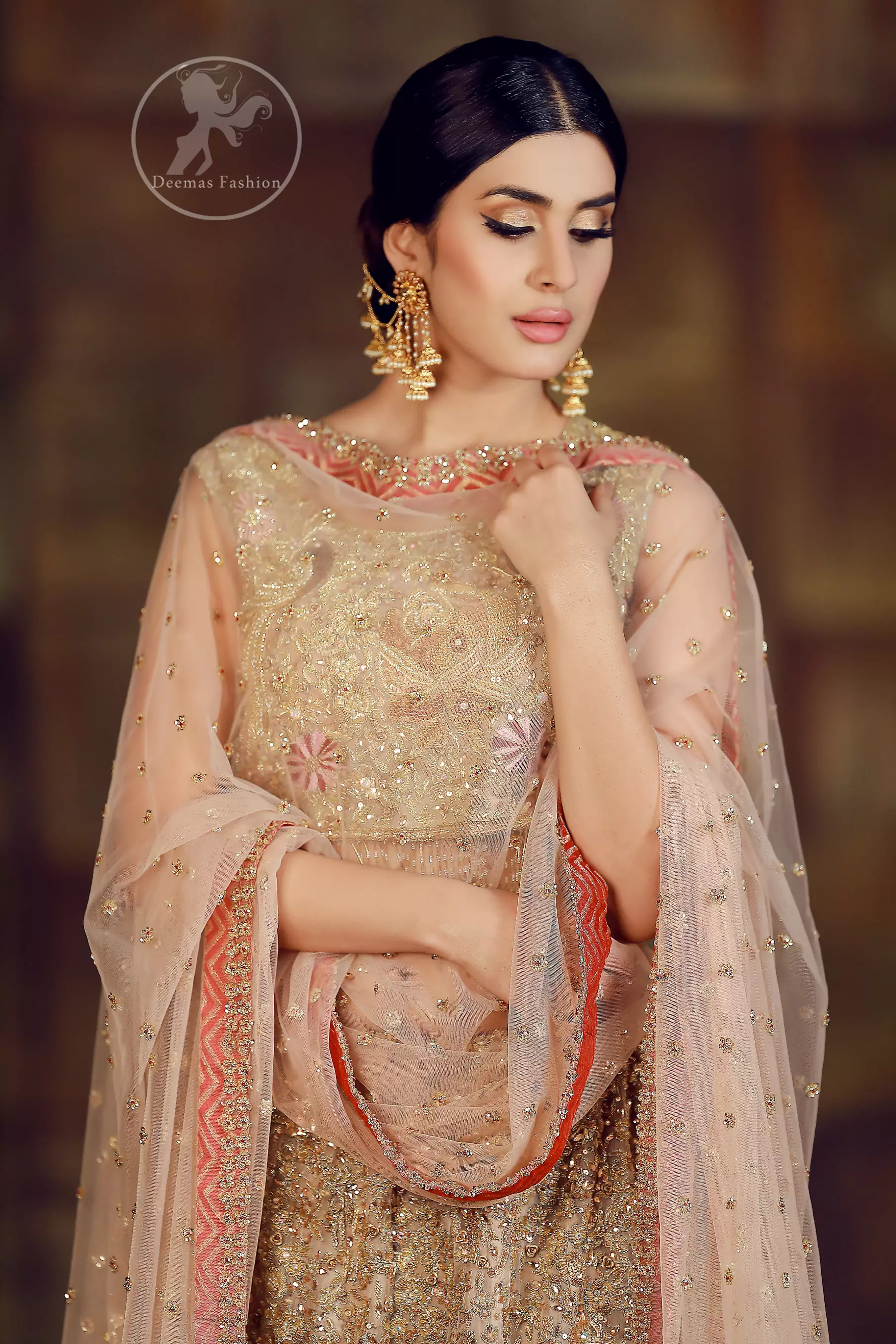 This dress is beautifully sculptured with floral thread embroidery. Blouse is fully embellished and decorated with tassels. Lehengha is embellished with different shaded thread embroidery, allured with kora, dabka, tilla, sequins and pearls. 