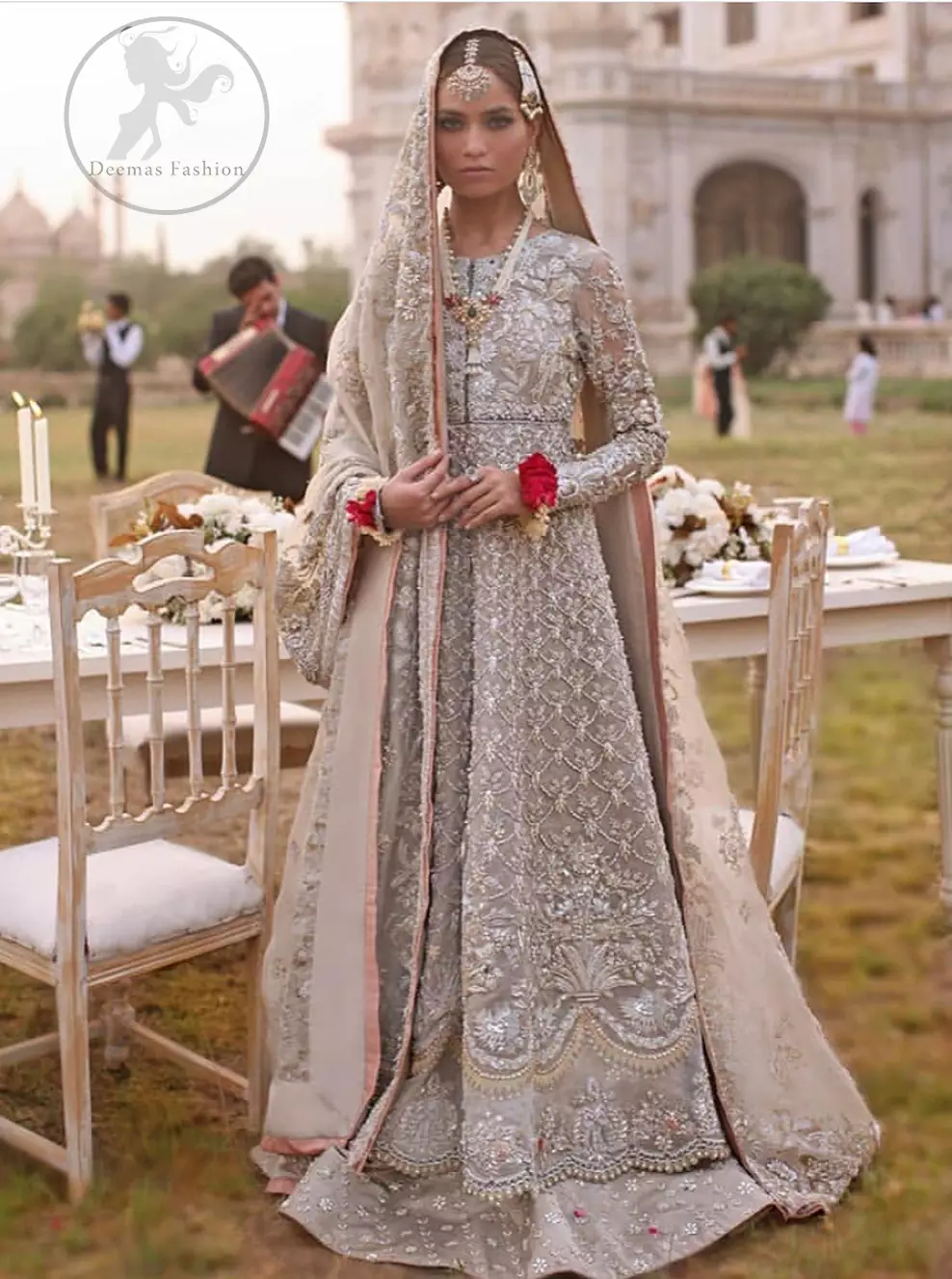 This outfit is a timeless beauty.It is heavily embellished with silver gold kora dabka, Sequins and swaronski crystals.This exquisite Pishwas is fully decorated with floral motifs patterns all over it.It is further enhanced with Foral thread embroidery.The trimming border of pishwas is ornamented with small golden pearls. It comes with embellished lehengha which has small sized sprinkled floral motifs all over.This Outfit is beautifully coordinated with matching Dupatta with heavy embroidered borders.