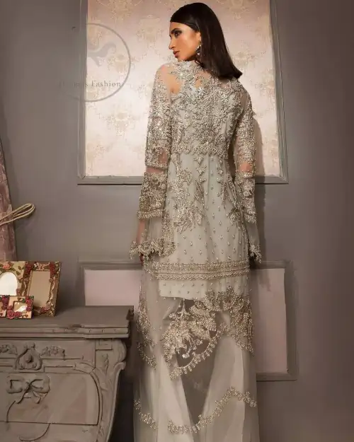 This beautiful gown is decorated with resham thread, kora, dabka, tilla, sequins and pearls. It is sculptured with floral thread
