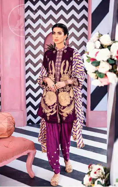 This outfit is a timeless beauty. It is embellished with golden kora, dabka, tilla and kundan. This shirt is fully decorated with floral motifs all over it. Round collar neckline ornamented with small sized floral patterns. It is further enhanced with golden floral thread embroidery. It comes with magenta shalwar which has small sized sprinkled floral motifs all over. This Outfit is beautifully coordinated with multiple colored lining dupatta.
