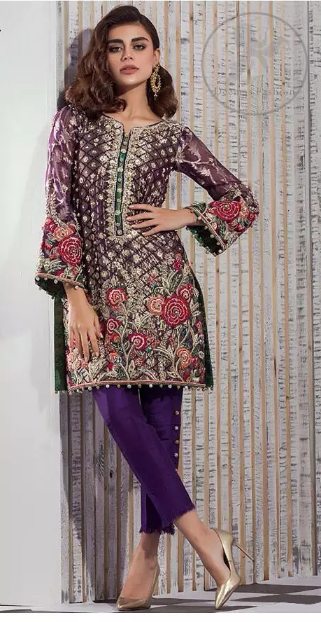 This outfit is beautifully sculptured with multiple color floral embroidery. The iridescent organza shirt is adorned with self print criss cross patterns. It is embellished with dull golden kora, dabka, tilla, and sequins work. Neckline is adorned with embellishments. It is artistically coordinated with chiffon dupatta with sprinkled sequins all over it. It comes with purple straight trousers.