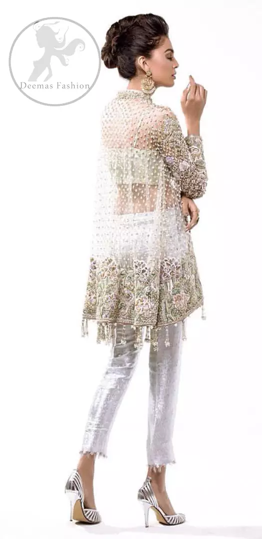 This classic outfit meticulously highlighted with silver golden kora, dabka ,tilla, sequins and pearls. This dress is beautifully sculptured with floral embroidery. The shirt is decorated with tassels and floral motifs on hemline which adds to the look. It comes with brocade pajama and beautifully decorated with net dupatta having sprinkled sequins all over it.