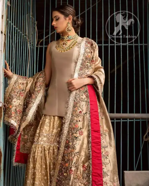 Ivory plain shirt is paired up with golden traditional gharara done with floral motifs all over. It is beautifully matched