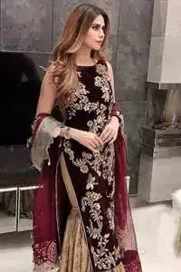 Take a step towards refreshing your wardrobe with maroon velvet dress. This maroon shirt is heavily embellished in the front with silver gold kora dabka, kundan, tilla and sequins. Finished with golden brocade self-printed gharara. This outfit is beautifully coordinates with maroon dupatta with embroidered borders on all four sides .