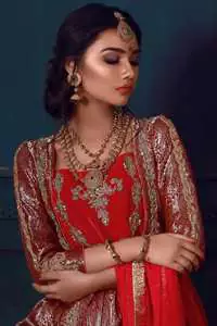 This dress is beautifully decorated with heavy embroidery. It is highlighted with kora, dabka, tilla, sequins and pearls. It comes with embroidered gharara. It is coordinated with chiffon dupatta which is sprinkled with sequins all over it. It is further furnished with four sided frilled lace.
