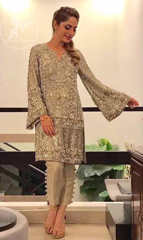 This dress is beautifully sculptured with floral embroidery. It is allured with kora, dabka, tilla, sequins and pearls. Bell shaped sleeves adds to the look. It comes with pants which is allured with buttons. It is coordinated with chiffon dupatta, sprinkled with sequins all over it.