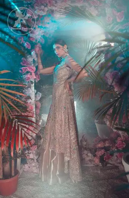 This dress is decorated with floral embroidery. It is highlighted with kora, dabka, tilla, sequins and pearls. Back trail frock adds to the look. It is allured with shamoz lining. It is coordinated with shamoz sharara. It comes with chiffon dupatta which is sprinkled with sequins all over it.