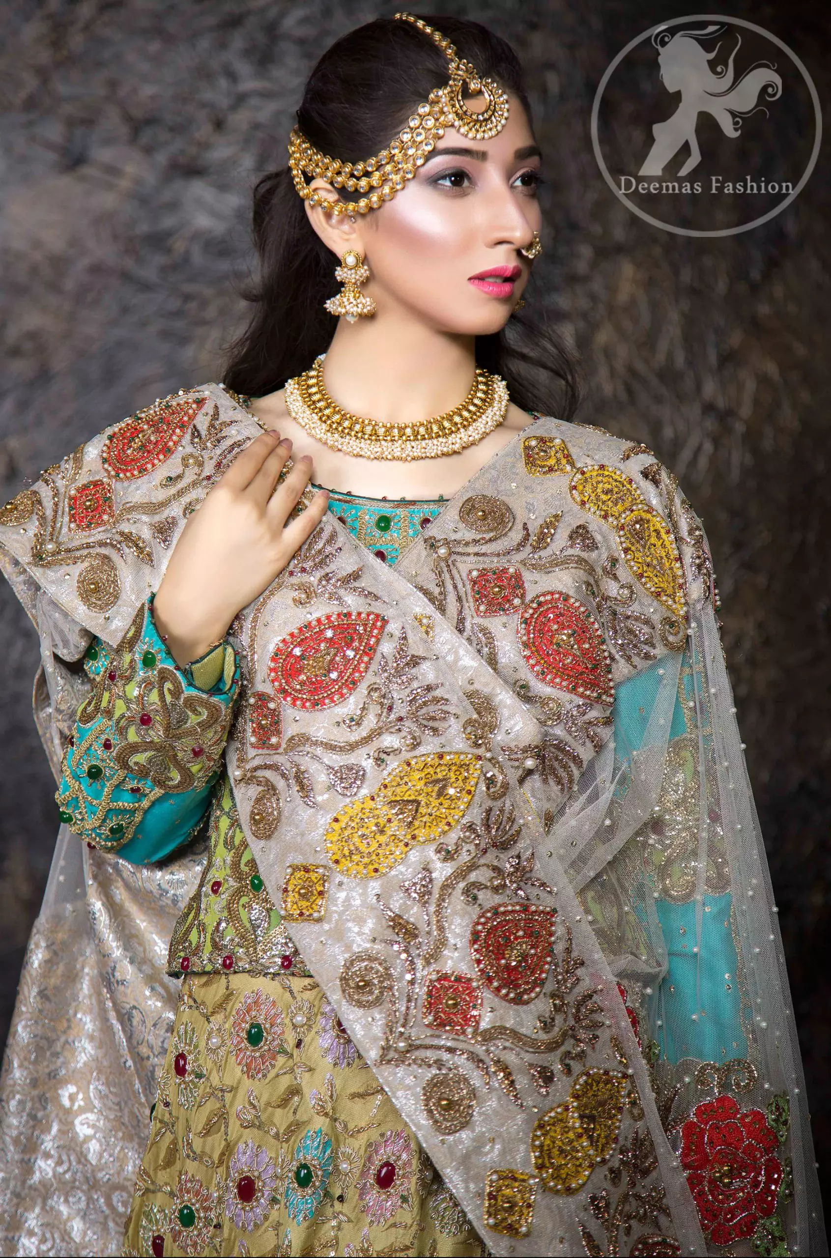 This outfit is adorned with kora, dabka, tilla, sequins and pearls. It is decorated with heavy floral embellishments. It comes with heavy embellished lehengha. A tissue dupatta accompanies the garment. The dupatta has embellished borders on all four sides and sequins spray all over it. The garment is lined with medium silk and finished with jamawar piping.