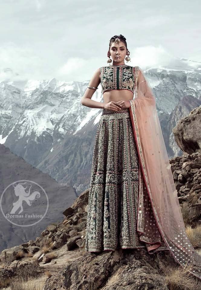 This dress is beautifully decorated with heavy embroidery. It is highlighted with dull golden kora, dabka, tilla, sequins and pearls. Fish lehengha is fully embellished.Blouse is scalloped. It comes with beautifull upper gown, sprinkled with sequins all over it. It is coordinated with chiffon dupatta which is sprinkled with sequins all over it.