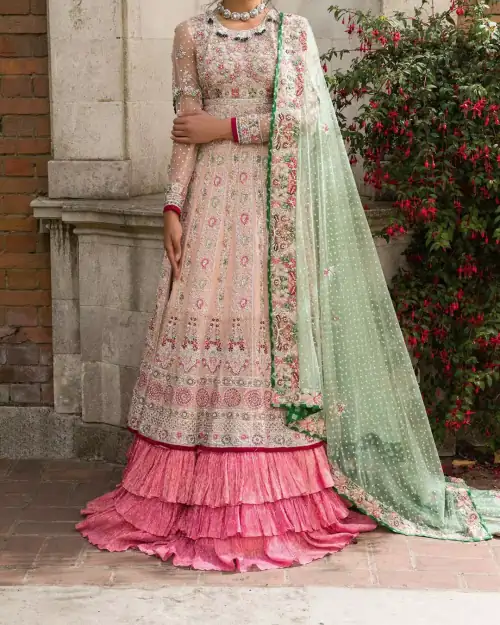 Opt for our ivory multiple-panel anarkali dress with exquisite embellishment on the bodice with pearls, sequins and silver kora, dabka.