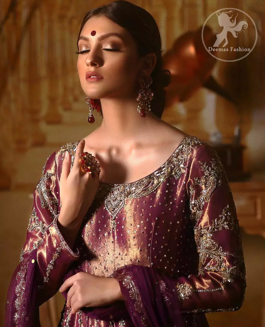Delicately crafted and personifying chic elegance with an element of grandiose. The detailed kundan work on neckline and vertical panel stripes ornamented with silver and antique shaded kora and dabka embroidery on the neckline, the thick scalloped borders and floral bunches refined the classical look. It comes with beautifull brocade churidar oajama. It is coordinated with organza dupatta which is decorated with gota work on the ground and zardosi work on all four sides of borders.