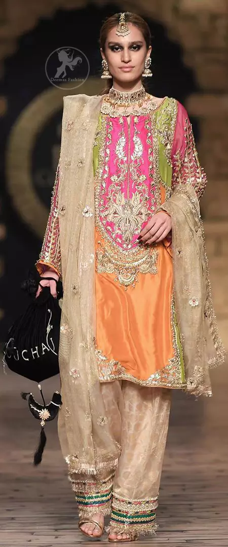 This dress is perfect for party wear due to its uniqueness and the perfect fusion of modern cut and traditional embroidery. It is beautifully decorated with heavy embroidery and the shirt is enhanced with embellished applique of two different colors. It is highlighted with kora, dabka, tilla, sequins and pearls. It comes with self printed shalwar which is enhanced with laces on bottom. It is coordinated with tissue dupatta which is sprinkled with small floral motifs all over it. It is further allured with laces all around the edges.