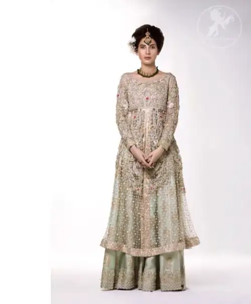 The perfect combination of tradition and class. Dazzle in this made to perfection, richly embroidered front open net outfit decorated