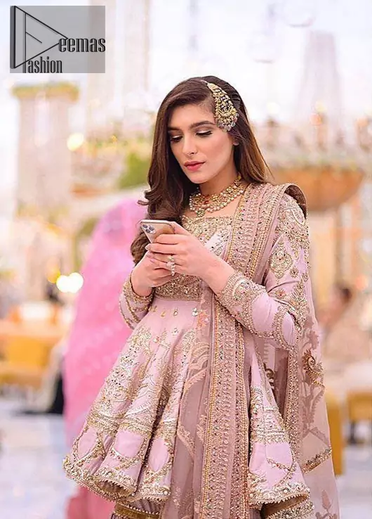 Brighten up your look with this outfit on your reception or nikah day. Wear this soft and supple hues richly decorated by shades of golden and silver with gota work motifs and geometric patterns at daaman. Having embellished bodice and full length sleeves adorned with geometric patterns and motifs. Style it up with artfully coordinated tea pink gharara finessed with floral motifs and gota work details at the bottom. Thin border on all four sides of the dupatta which have gold tila embroidery with sequins, beads and crystal touching.