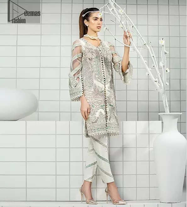This formal wear dress is majestic beauty. Delicately crafted and personifying chic elegance with an element of grandiose. A full heavily embroidered front open shirt with silver zerdozi work details all over. The daaman is furthermore highlighted with embellished border. Having full length sleeves adorned with silver kora, dabka and tilla embroidery. Paired up with organza straight trouser decorated with embroidered lace. It comprises with chiffon dupatta having sprinkled sequins on the ground.