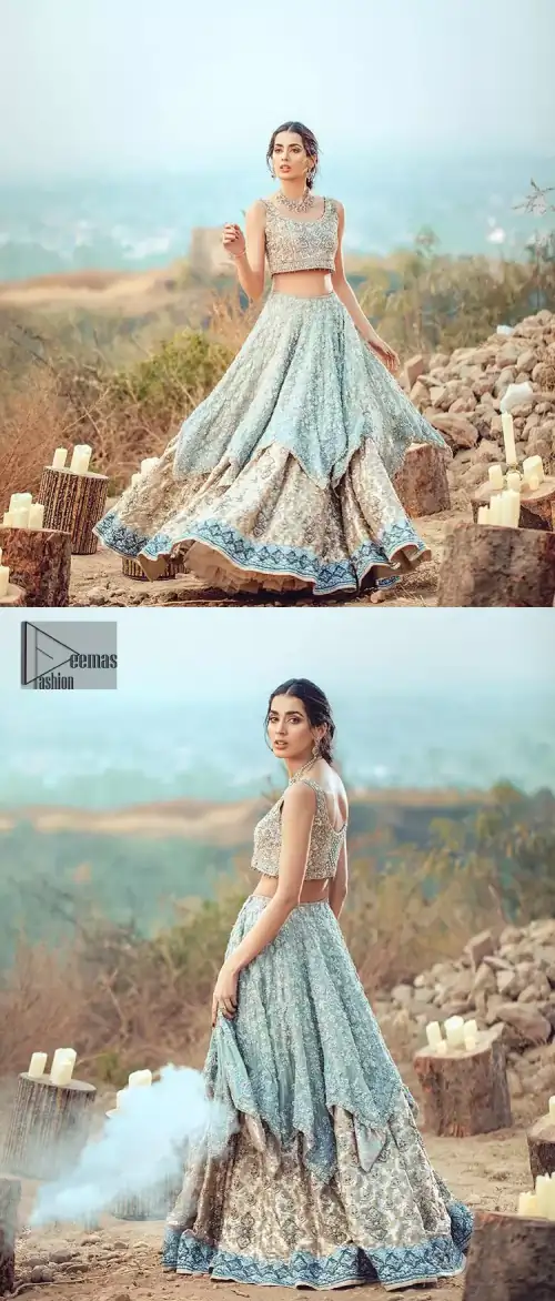 This bridal dress executing heavily hand crafted art of zardosi, kora and dabka with splashes of golden and silver is