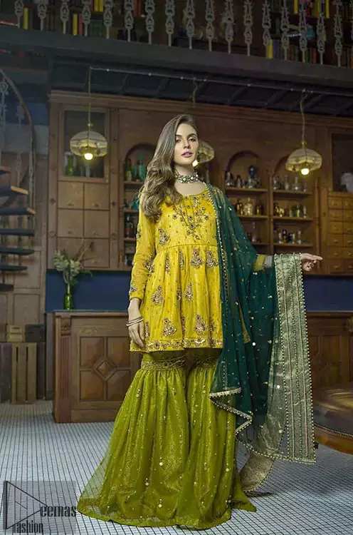 This dress is perfect for mehndi day. Delicately crafted and personifying chic elegance with an element of grandiose. This mehendi and mayun dress is beautifully sculptured with floral embroidery on neckline adorned with scattered embellished with dull golden kora, dabka, pearl and sequins work all over. Having full length sleeves adorned with motifs. It comprises with mehndi green gharara sprinkled with sequins to convey a classic style. Beautifully coordinated with bottle green dupatta with thick lace border.