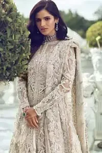 Captured in traditional silhouette, The bridal stands out due to its uniqueness and the perfect fusion of modern cut and traditional embroidery. It is highlighted with silver and light golden kora, dabka, tilla, sequins and pearls. It comes with heavily embellished front open back trail gown ornamented with floral embroidered  motifs and geometric patterns. Paired up with ivory lehenga done with light gold embroidery. It is coordinated with chiffon dupatta which is sprinkled with sequins all over it. It is further furnished with four sided border.