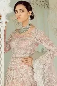 An example of beauty and elegance. Look breathtakingly stylish in this embroidered regalia furnished with intricate embroidered neckline. This ethereal maxi highlights the collision of heritage and beauty of traditional zardosi craftsmanship with modern chic silhouette. Beautifully designed sleeves is an amalgamation of geometric and floral design elements. The light pink net dupatta with chann and scalloped applique border all around the edges makes the look complete.