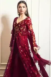 This exceptionally detailed front open gown lehenga is cut in a seductive fit and flare silhouette that’s sure to turn heads on your big day. The bodice with plunging V-neckline is adorned in richly floral lace with fabulous sparkle. Furthermore the bodice is highlighted with golden zardozi work and floral applique. Center slits and bottom of the gown is beautifully decorated with floral lace. It is coordinated with maroon crushed lehenga and organza dupatta. 