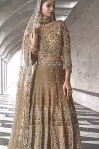 An example of beauty and elegance. Our bride makes a statement in this stunningly floraison, perfect blend of glamour and tradition with outstanding craftsmanship and gorgeous detailing. The cold shoulder blouse is stunningly embellished with intricate embroidered neckline done with light golden and silver zardosi work all over. Lehnga is compiled with zardozi embellishment which gives this festive season a flattering dimension to die for. The outfit is coordinated with beige net dupatta adorned with scattered sequins all over and four sided border.