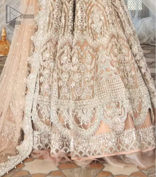 Paint a picture of pure elegance with this beautiful pishwas. This dress is beautifully sculptured with floral embroidery, adorned with geometric patterns embellished with silver kora, dabka, pearls and sequins work all over. The detailed scallop border gives a perfect ending to this pishwas. The lehenga is emphasized with embellished bottom that gives perfect ending to thisoutfit. It is coordinated with net dupatta sprinkled with chann all over and finished with embroidered border on four sides which makes this outfit more beautiful.