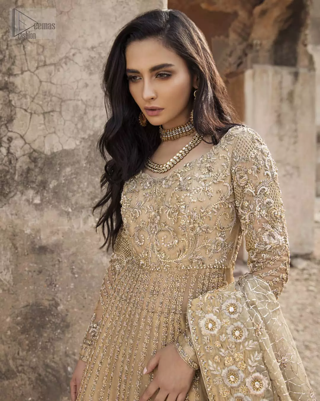 Captured in traditional silhouette, The bridal stands out due to its uniqueness and the perfect fusion of modern cut and traditional embroidery. It is highlighted with kora, dabka, tilla, sequins and pearls. Pishwas is enhanced with zardosi work on bodice, vertical lines and the daaman is emphasized with intricate zardosi details that gives perfect ending to this outfit. A handcrafted pale gold lehenga finished with thick embellished borders completes the look. The outfit is coordinated with chiffon dupatta with hand embroidered borders on all four sides and geometric patterns on the ground.