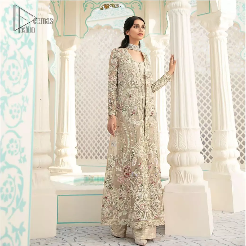 An example of beauty and elegance. A perfect ensemble for this festive season with divine detailing of thread embroidery, color balance and well-crafted scalloped bottom. The front open gown is sculptured with light golden zardozi work all over and multiple color thread embroidered floral. Complete the look with inner jumpsuit style it up with a fixed waist belt. Paired it up with organza dupatta adorned with scattered floral motifs.