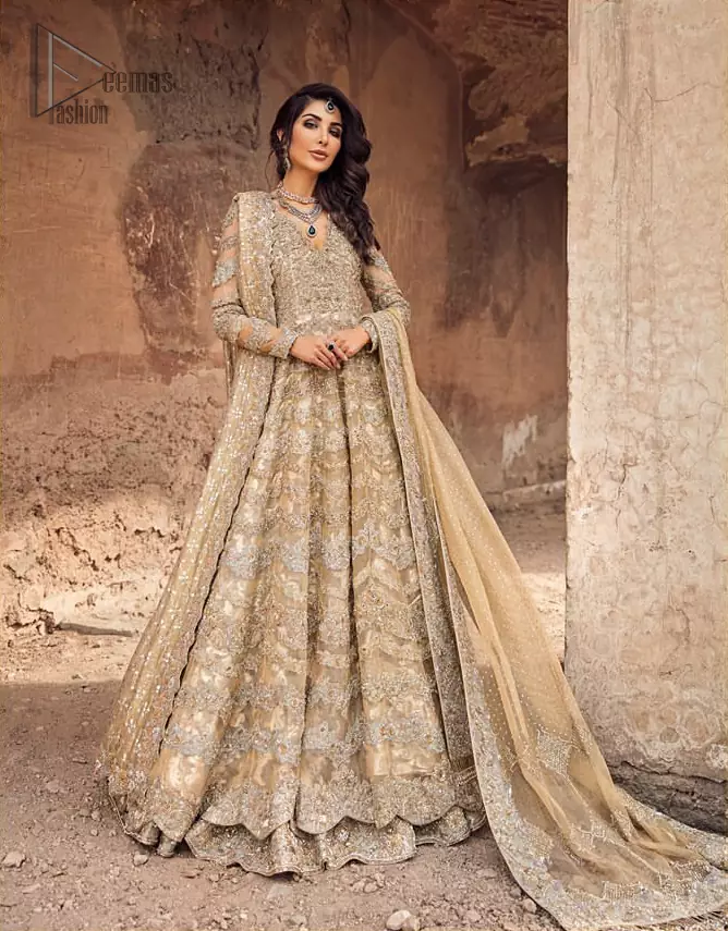 This artisanal piece is rendered in grace and timelessness. The floor length maxi highlights the collision of heritage and beauty of traditional zardozi work and craftsmanship with modern chic silhouette. The bodice with plunging V-neckline is adorned in richly zardozi work with fabulous sparkle. It boasts a pretty scallop hemline. The lehnga is done with thick kora and dabka borders to completes the look. This outfit is comprises with chiffon dupatta sprinkled with sequins on the ground and and four sided border.