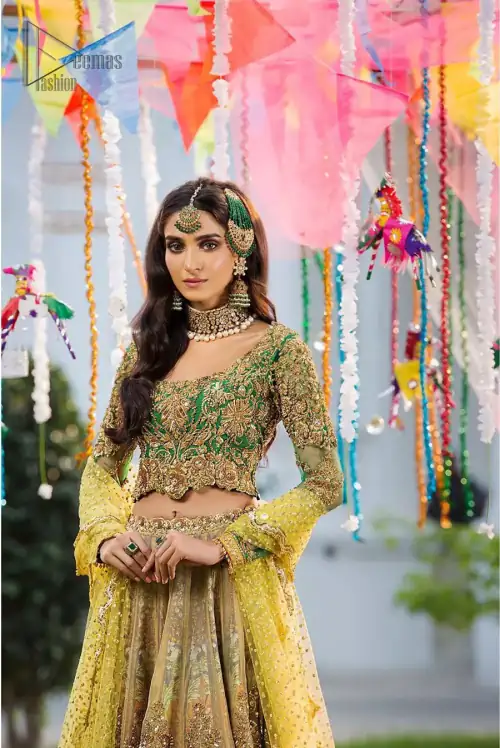 A perfectly pretty combination for a mehndi function. Gussy up the glamour with this intricate embroidered blouse accentuated with golden