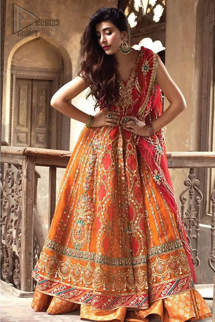 This artisanal piece is rendered in grace and timelessness. Brighten up your look with this mix of floral and geometrical embroidery in vibrant tones spread across on red and orange canvas. The front open pishwas is delicately crafted with zardozi work, multiple color embroidery and mirror work. Furthermore it is also adorned with green embellished applique and the colorful applique lift the whole bottom. It comprises with orange sharara. Finished the dress with red and orange organza dupatta with geometric patterns on the ground.