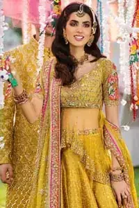 The perfect choice for Mahendi. Delicately crafted and personifying chic elegance with an element of grandiose. The shirt is emphasized with traditional neckline and a small back train. And the lehenga is decorated with intricate floral daaman enhanced with multiple color thread embroidery and rich zardozi work. Paired it up with yellow net dupatta sprinkled with sequins on the ground and four sided applique border.