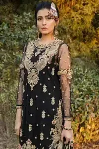 This elegant ensemble turns timeless piece into a chic fantasy. Steal the show with this endearing chiffon outfit with intricate yet rich embroidery. Artfully crafted neckline with detailed golden zardozi work. The hemline is ornamented with a central large motif and adorned with jaal. Furthermore, side slits are also decorated with floral embroidery and floral motifs are decorated with multiple color thread embroidery. The back is perfectly loaded with zardozi work. This outfit is comprises with black sharara and chiffon dupatta having sequins spray all over.