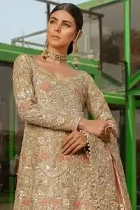 Nothing speaks of femininity and class louder than this outfits for bridesmaids. It is highlighted with golden and silver kora, dabka, tilla, sequins and pearls. The maxi is heavily ornamented with floral jaal done with zarozi work and floral motifs are decorated with peach and ivory thread embroidery. It comes with fawn lehenga adorned with scalloped embroidered bottom. Furthermore, lehenga is enhanced with peach frilled bottom. It is coordinated with peach dupatta which is sprinkled with sequins all over it. It is further furnished with four sided thick border.