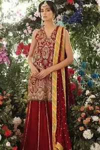 Tradition meets modernity. Boost your confidence and style in this glamorous attire accentuated with finest zardozi work embroidery and scalloped borders with dandling pearls. This maroon sleeveless shirt is ornamented with golden and light golden zardozi work. The scalloped hemline is decorated with dangling pearls. Style it confidently with maroon sharara adorned with beautiful gota work. It is paired with an ethereal maroon dupatta with scattered sequins all over and four sided applique borders.