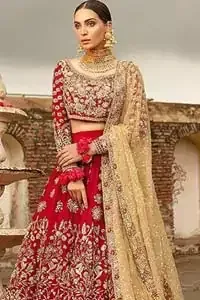Our deep red bridal dress will make your special day even more perfect. Infused with classical glamour. Strike a breathtakingly elegant pose in this wedding dress. This artisan piece includes intricate hand embellishment. This highly skilled technique involves hand needle work to add beads and sequins to the fabric, giving your garments a unique look. The embroidery is done in the shades of light golden, antique and maroon thread work. The blouse is fully embellished and lehenga is adorned with floral details all over and thick embellished bottom. Furthermore the lehenga is also intensified with sprinkled floral motifs. Complete the look with golden net dupatta enhanced with sprinkled sequins on the ground and four sided embellished border.