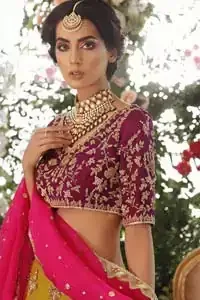 Adorn yourself with this breath-taking mehndi lehenga outfit. This beautiful mehndi dress comes with yellow lehenga with scattered beautiful embellished motifs and floral booties around a large central motif and it finished with frilled border. It is coordinated with a beautiful plum blouse adorned with zardozi work in the shades of golden and silver. Style it up with pink organza dupatta with sequins sprayed all over it along with gota finishing on all four sides.