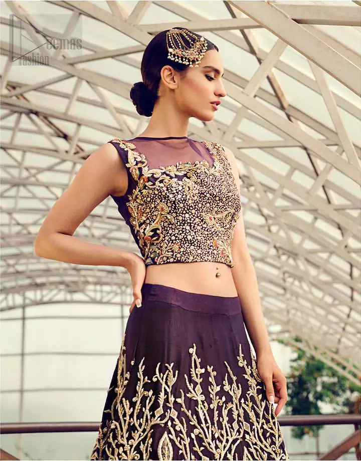 Captured in traditional silhouette, The bridal stands out due to its uniqueness and the perfect fusion of modern cut and traditional embroidery. This dress is beautifully decorated with heavy embroidery. It is highlighted with light golden kora, dabka, tilla, sequins and pearls. Blouse is fully enhanced with zardosi work and multiple color embroidery. It comes with full embellished lehenga adorned with floral booties and heavy embellished bottom. It is coordinated with plum organza dupatta which is sprinkled with sequins all over it.