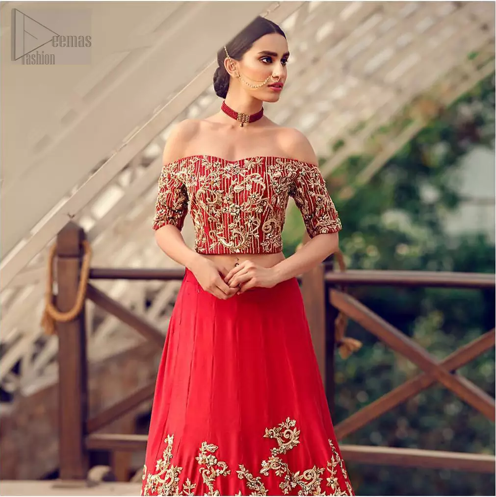 Captured in traditional silhouette, The bridal stands out due to its uniqueness and the perfect fusion of modern cut and traditional embroidery. This dress is beautifully decorated with heavy embroidery. It is highlighted with kora, dabka, tilla, sequins and pearls. Off shoulder blouse is enhanced with zardosi work all over. It comes with full embellished lehenga adorned with floral booties and vertical lines all over it. It is coordinated with net dupatta which is sprinkled with sequins all over it. It is further furnished with four sided embellished border.