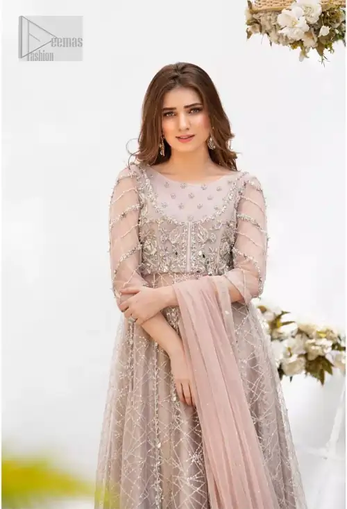 Embrace the season of festivities with this beautiful dress. Dazzle in this made to perfection, richly embroidered net outfit decorated