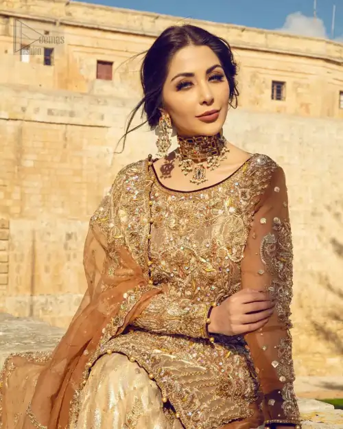 Dazzle in this made to perfection, richly embroidered ensemble accentuated with floral motifs and finished with scalp borders. Excellence of