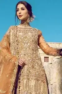 Dazzle in this made to perfection, richly embroidered ensemble accentuated with floral motifs and finished with scalp borders. Excellence of craftsmanship is evident with intricate detailing that features the use of kora, dabka, crystals, sequins and pearls. The Scalloped hemline is emphasided with dangling pearls. Balance the look with light golden lehenga adorned with golden, silver and antique shaded zardozi work. Dupatta comes with embellished alluring cut work floral border gives the perfect ending to this peplum.