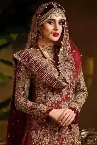 Captured in traditional silhouette. The bridal stands out due to its uniqueness and the perfect fusion of modern cut and traditional embroidery. This dress is beautifully highlighted with zardozi work in the shades of tan and silver. The hemline of the shirt is adorned with scalloped finishing and tassels on the sleeves. It comes with katan banarsi gharara with wide flare decorated with kora, dabka, tilla and pearls work. It is coordinated with organza dupatta which is sprinkled with sequins all over it. It is further furnished with four sided scalloped border.