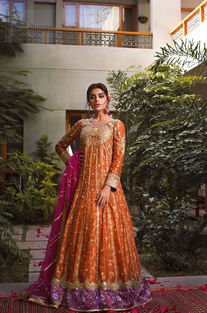 Let the crowd stare and make it worth their while when you walk wearing this anarkali frock. Designed to flaunt your best features, the bodice carries intricate zardozi work. Furthermore this multiple panel frock is enhanced with gota work and beautiful applique on bottom embellished with golden kora, dabka, tilla, sequins and beads work. Pair it up with pink churidar pajama and pink organza dupatta emphasized with gota work and four sided kiran lace. Upholding the idea of simple is beautiful, you would definitely want to wear this for your next occasion.