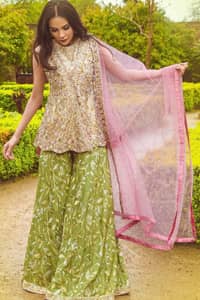 Wear this soft and supple hues richly decorated by shade pink with zardozi embroidered motifs and floral bootis all over the shirt. The outfit is finished by beautiful overlaping and scalloped hemline. It comes with an exquisite sharara with embroidered border and floral bootis all over to give it a regal look. The outfit is coordinated with pink net dupatta having sequins spray all over the ground and zardozi embellished borders along the length.